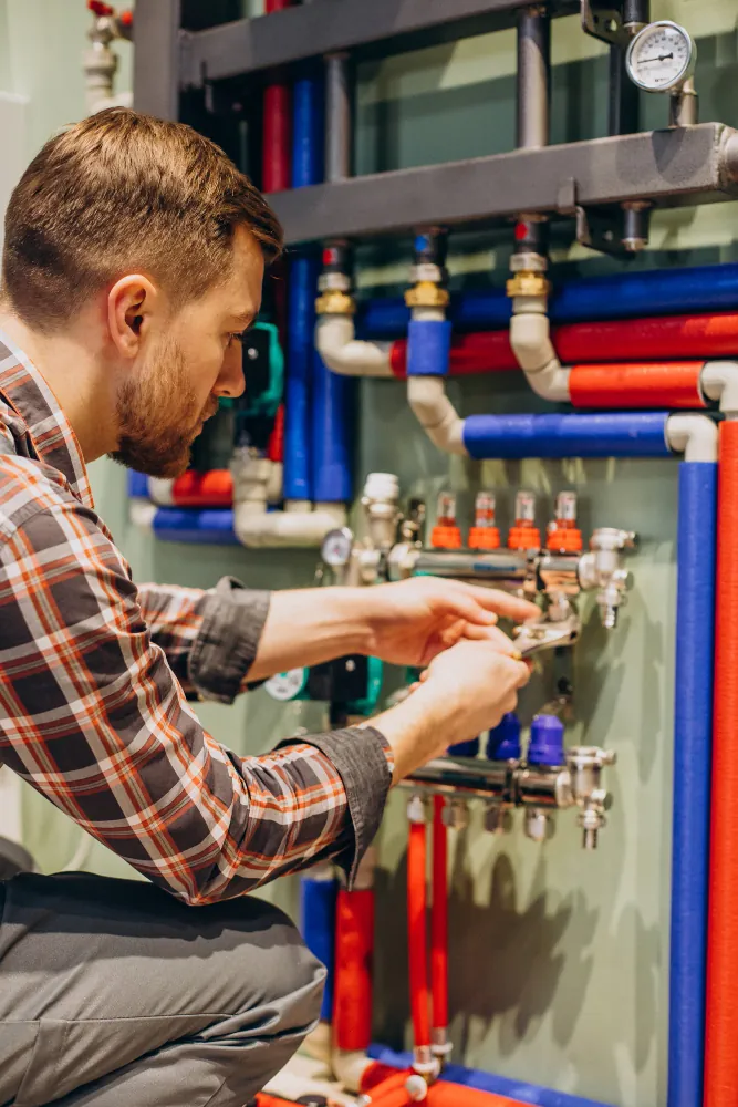 OnCall plumber working on a hot water manifold